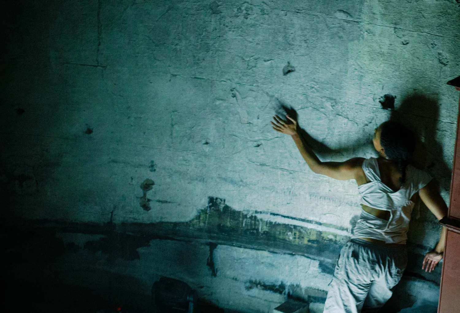 A performer against a rough wall