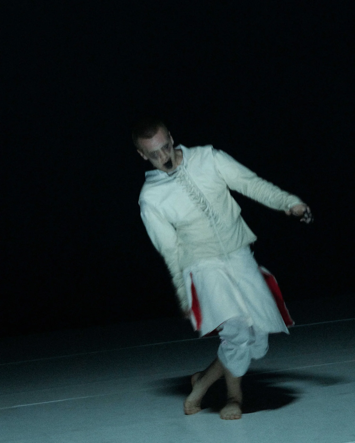 A performer beneath a bed